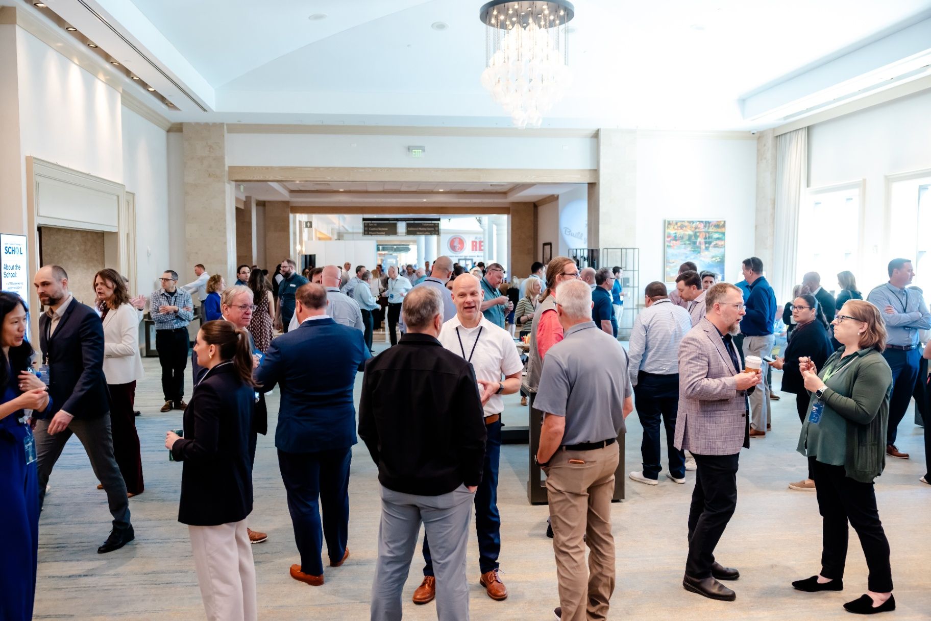 professionals networking at a busy corporate reception in a bright event venue