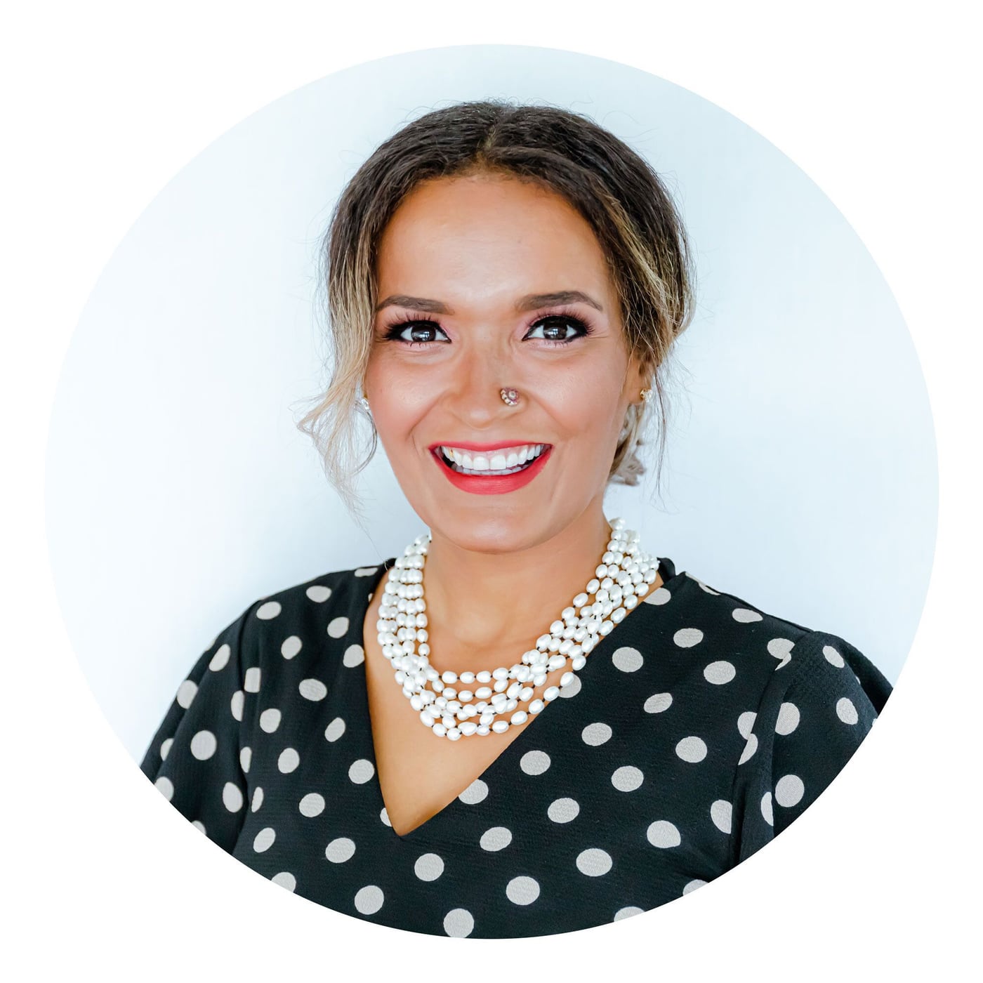 Denisse, owner and lead photographer of Lotus Eyes Photography, smiling in a portrait.
